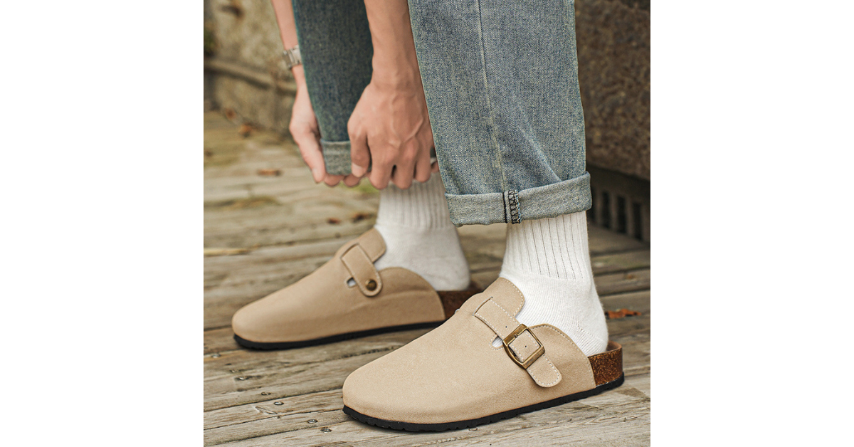 Elegant tan clogs on light wood floor