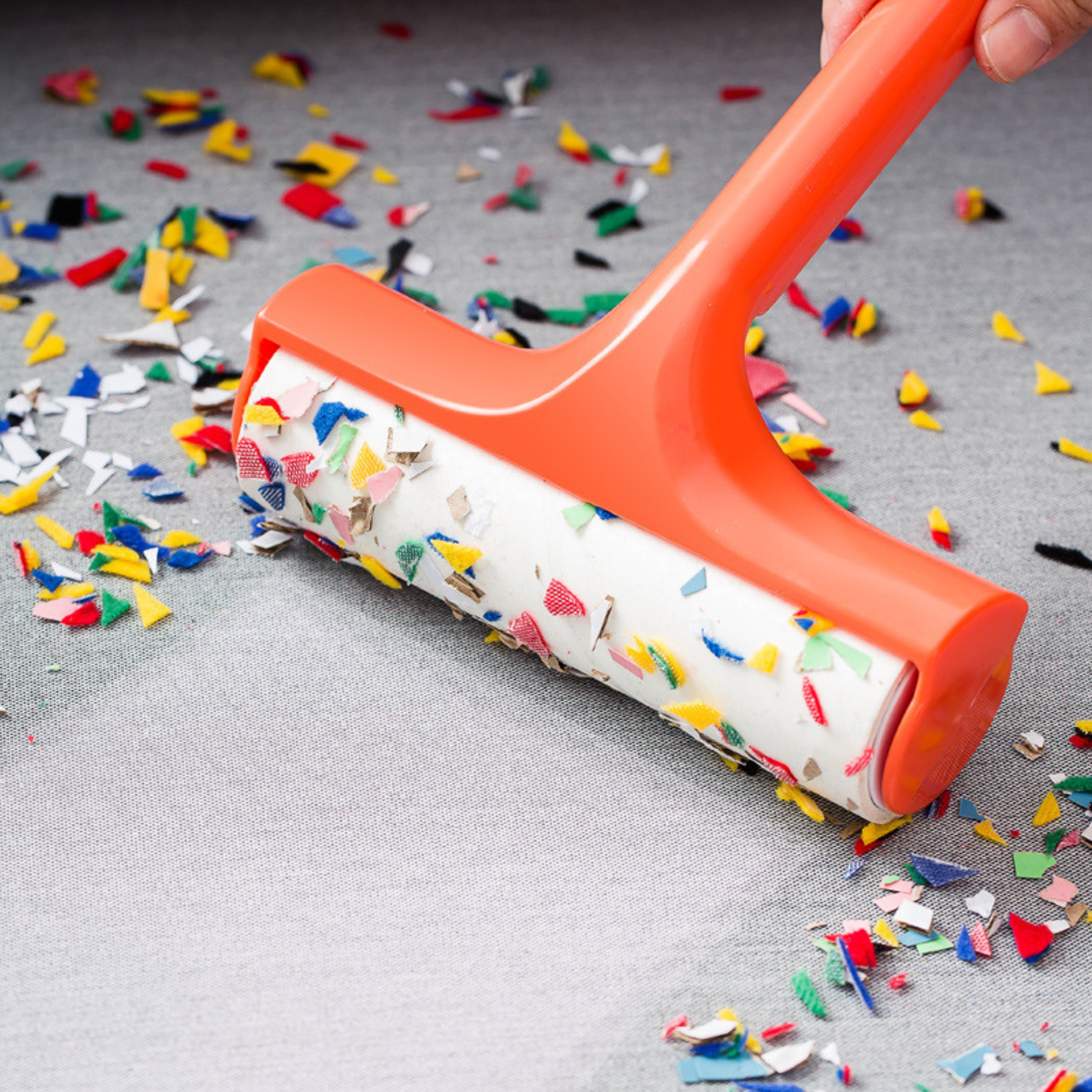 Plastic lint roller household cleaner used for quick fabric maintenance on chairs and cushions.