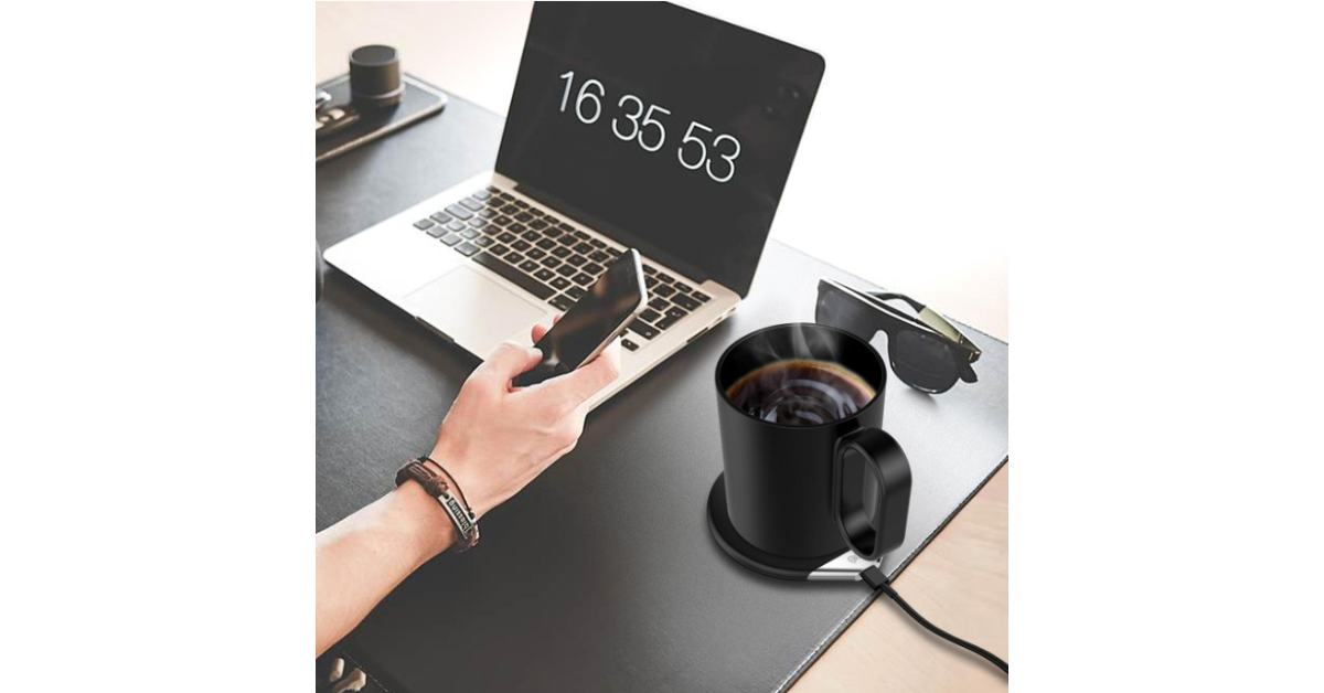 USB mug warmer beside laptop computer
