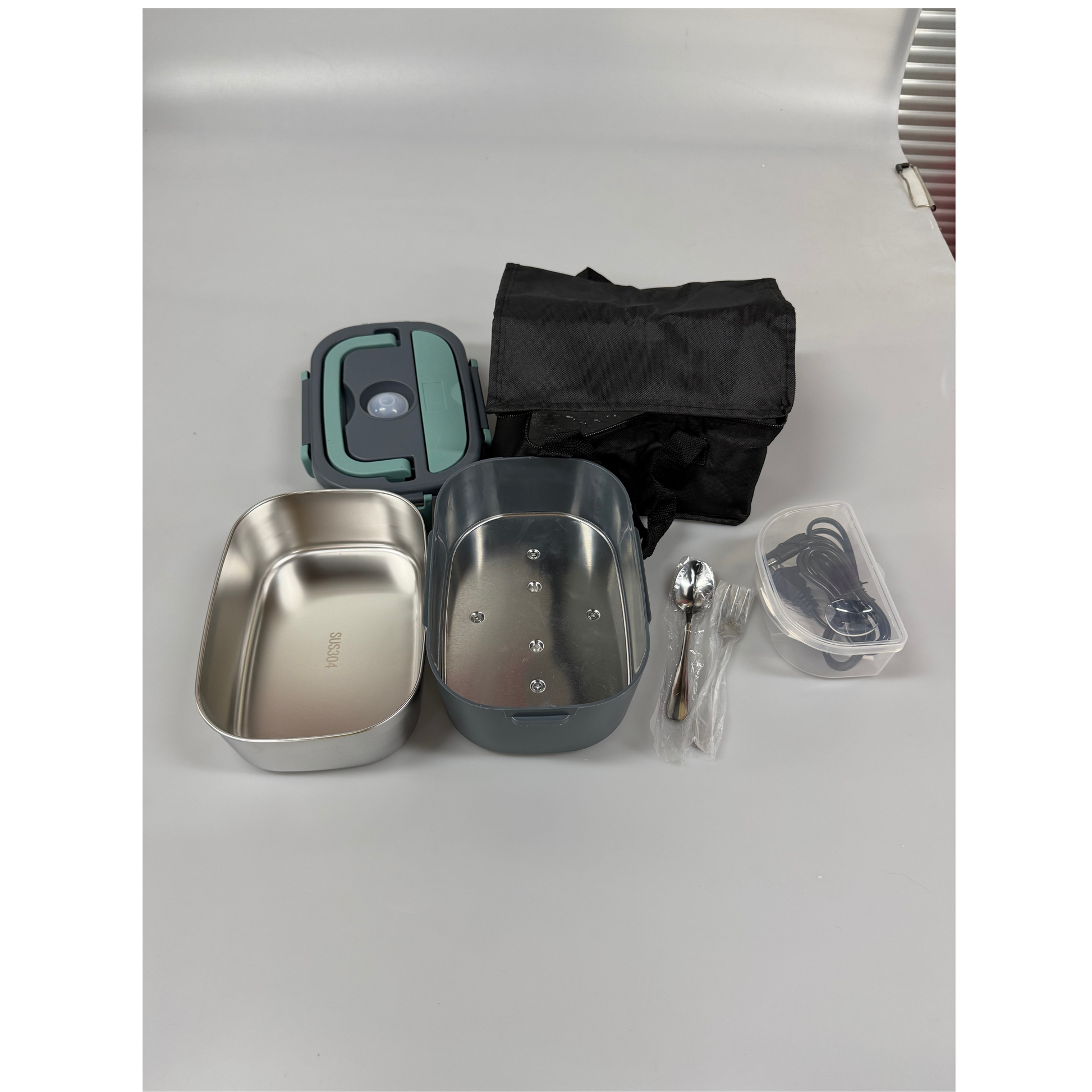USB Heated Lunch Box connected to a power source for warming food during office hours, car trips, and outdoor adventures.